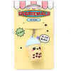 Front view of a 3D PVC bubble tea keyring, shaped like a character with a light blue lid, purple straw, yellow cup, and cute face with pink cheeks. The keyring is presented on a bright yellow backing card with cartoon illustrations.