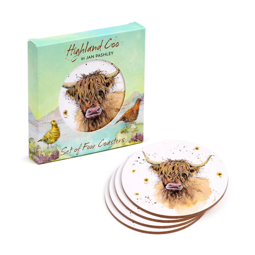 Angled view of four round cork coasters, stacked, each displaying a shaggy brown Highland Coo illustration, beside a light green presentation box featuring the same coo design.