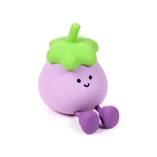 Angled view of a round, purple night light character with a green leafy top, black dot eyes, and a smiling mouth. The character is depicted sitting with two purple legs on a white background.