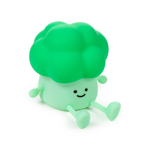 Angled front view of a smiling green broccoli night light, featuring a lighter green body, darker green textured top, and small limbs.