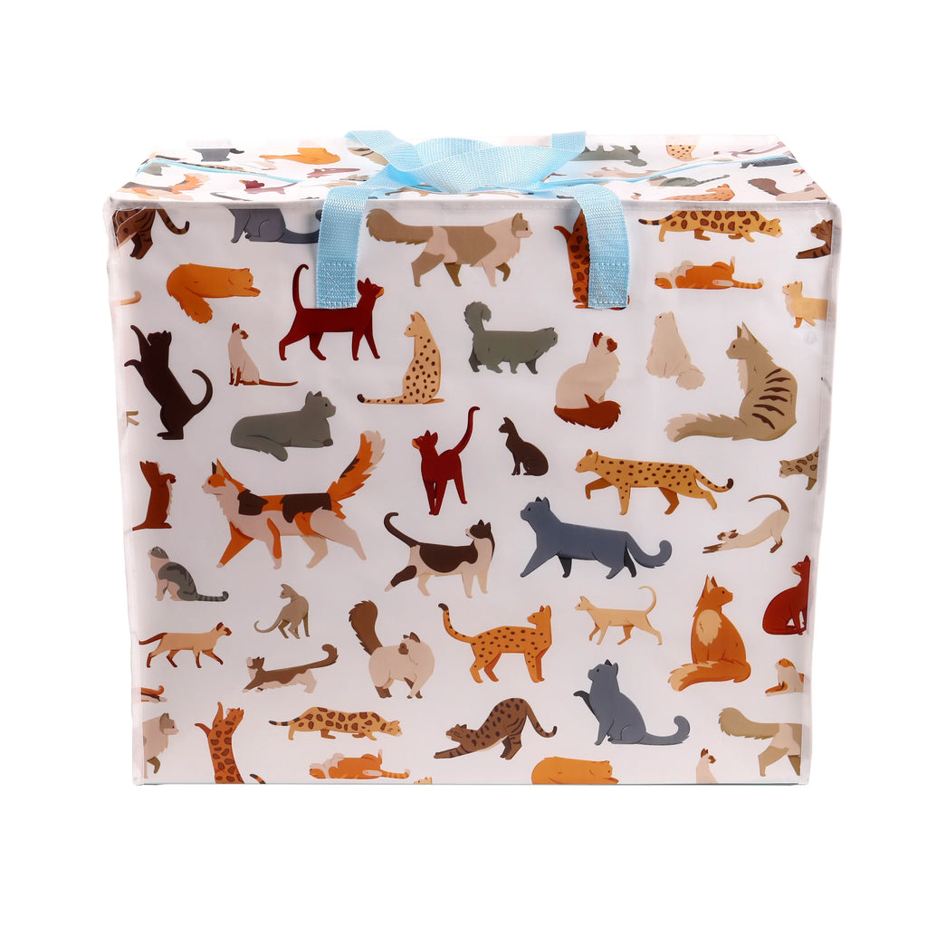 Front view of a white laundry and storage bag featuring a colourful feline pattern with various cat illustrations, complete with blue fabric handles and a blue zip closure.