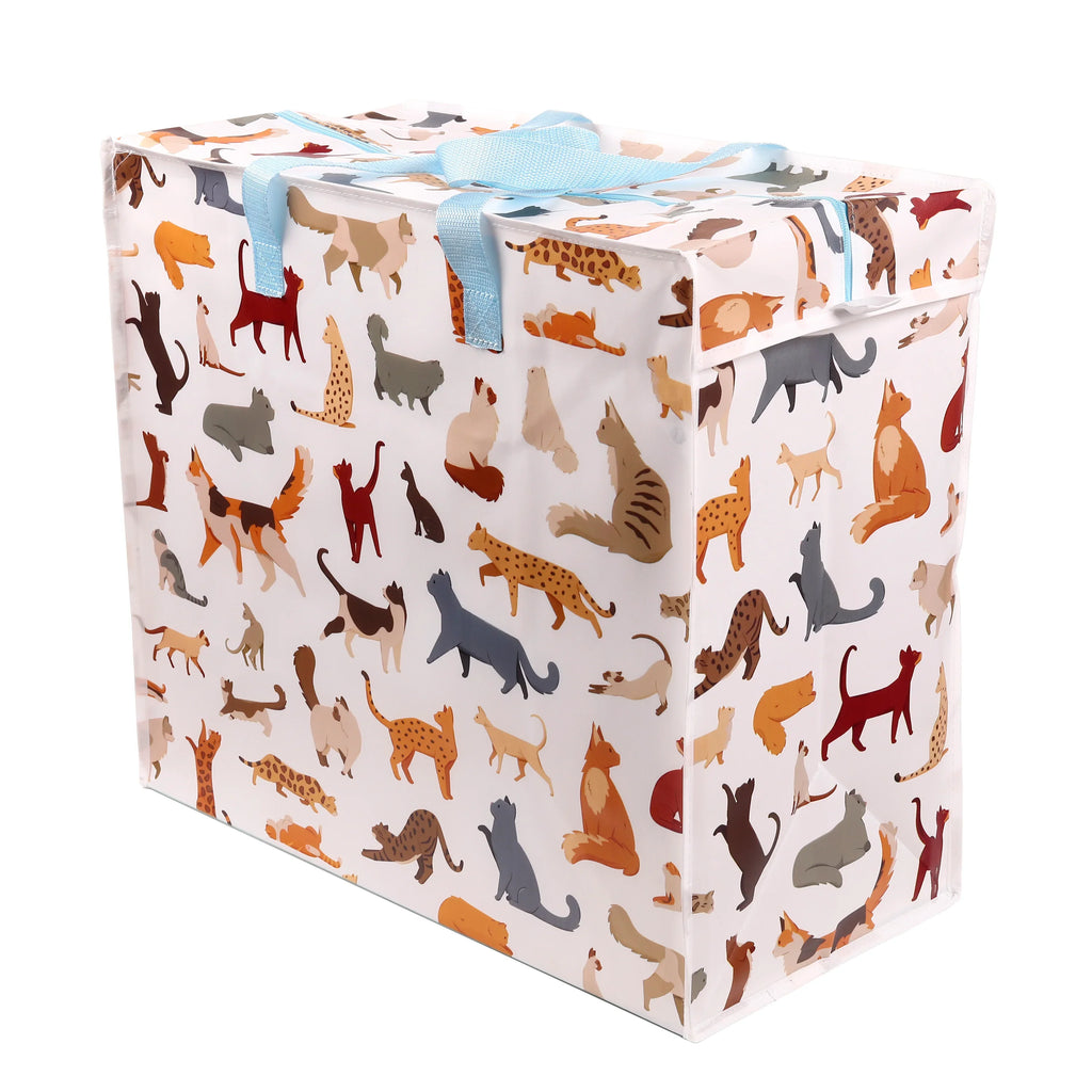 Angled view of a white laundry and storage bag featuring a colourful feline cat pattern and light blue top handles tied in a bow.