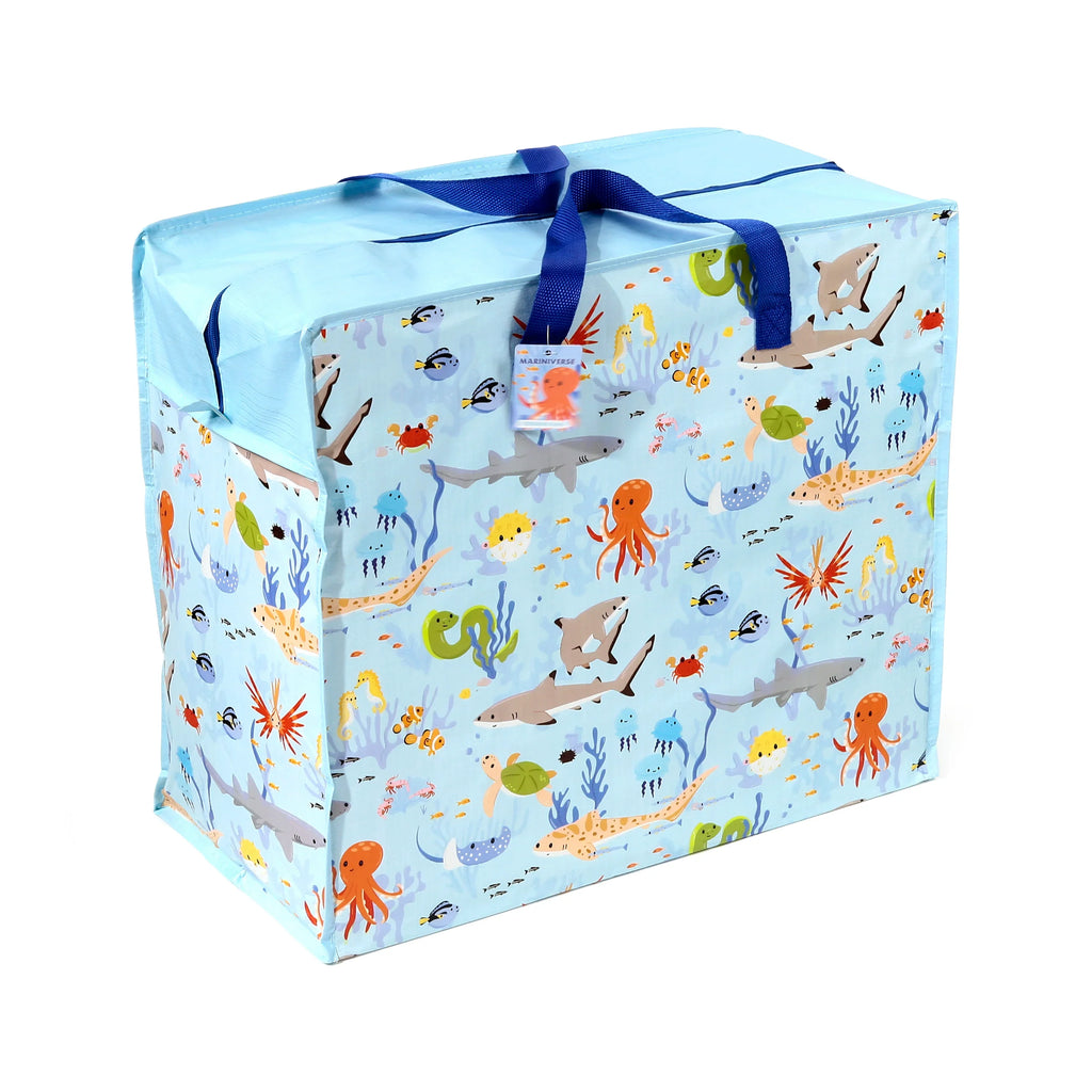 Angled view of a light blue laundry and storage bag, featuring a vibrant marine life pattern with sharks, octopuses, and turtles. The bag has dark blue fabric handles and a visible zip closure on top.