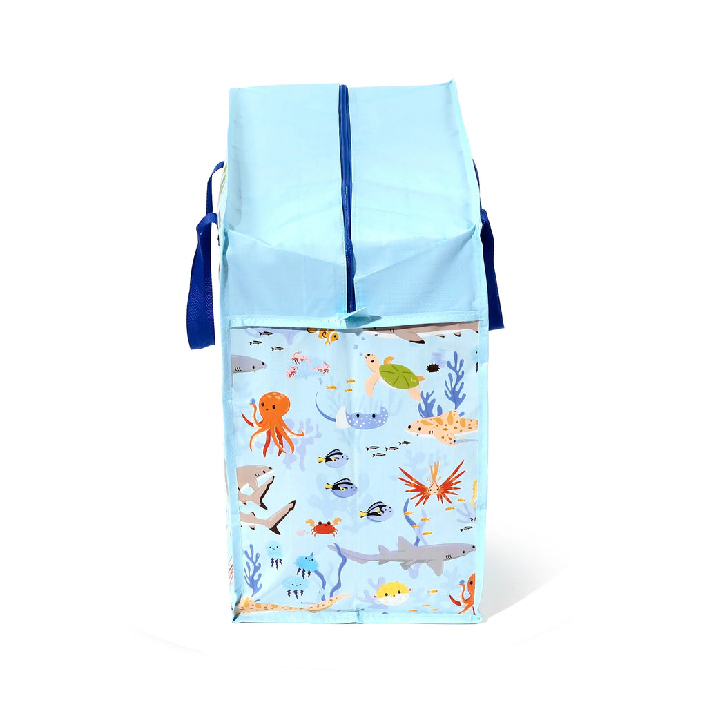 Front view of an upright light blue laundry and storage bag, featuring a vibrant Mariniverse sea creature pattern including an octopus, shark, and various fish, with a dark blue zip across the top.
