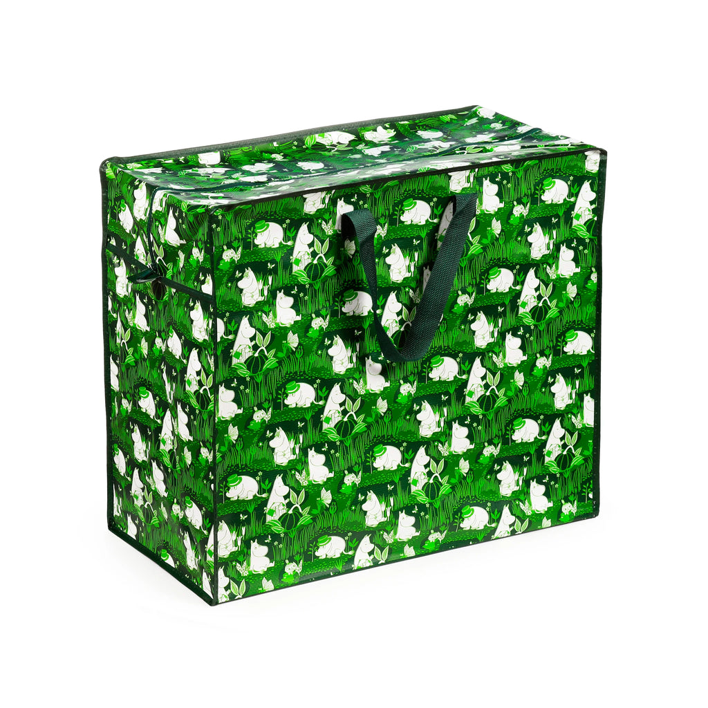 Angled view of a rectangular, green laundry and storage bag featuring a pattern of white Moomin characters amidst green plants and butterflies. It includes dark green fabric handles and a zippered top.