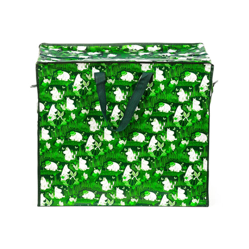Angled front view of a green laundry and storage bag with a white Moomin characters, plants, and butterflies pattern. It features dark green fabric handles and a zipped top closure.