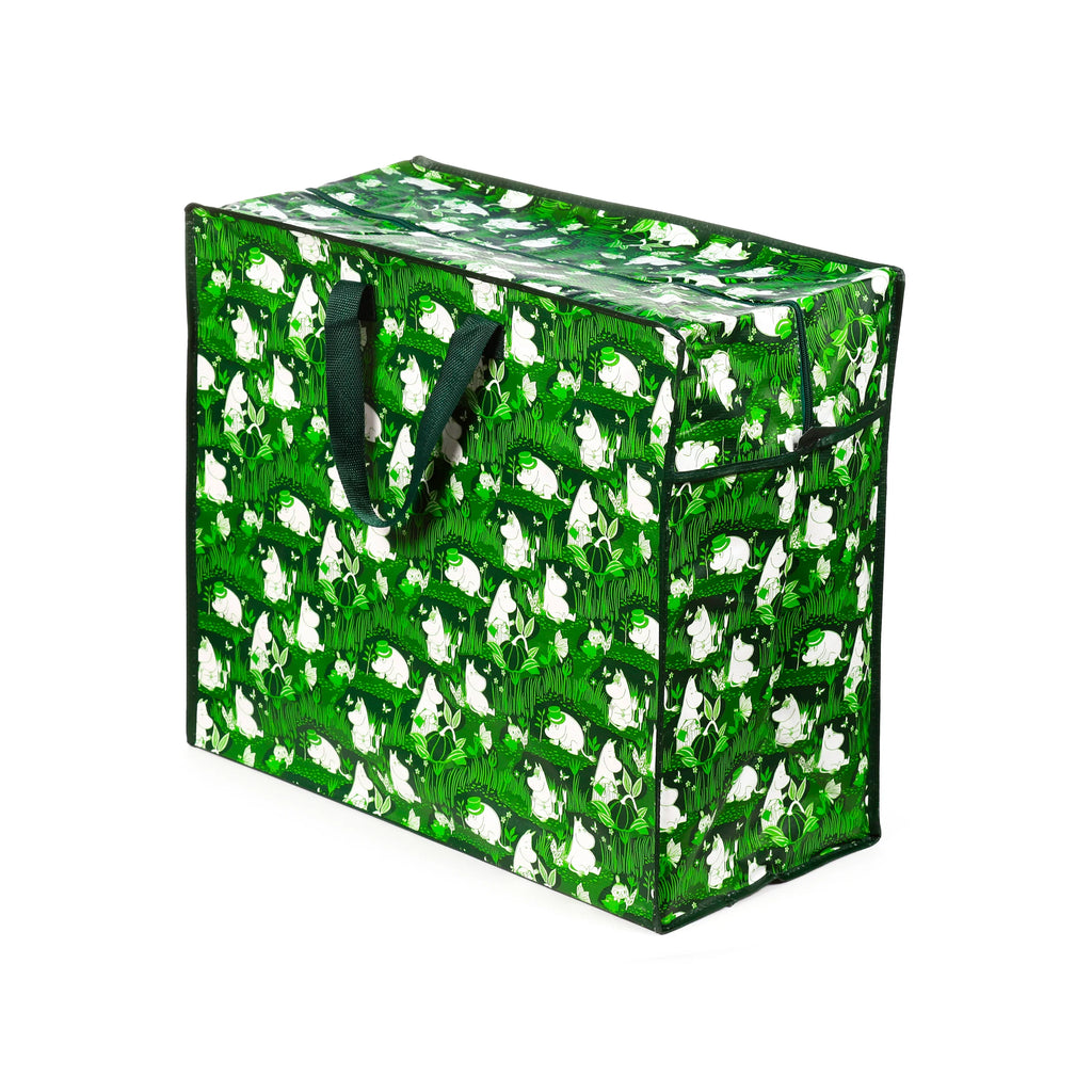 Angled view of a green and white Moomin Garden Life laundry and storage bag, featuring Moomin characters and a foliage pattern, with dark green fabric handles.