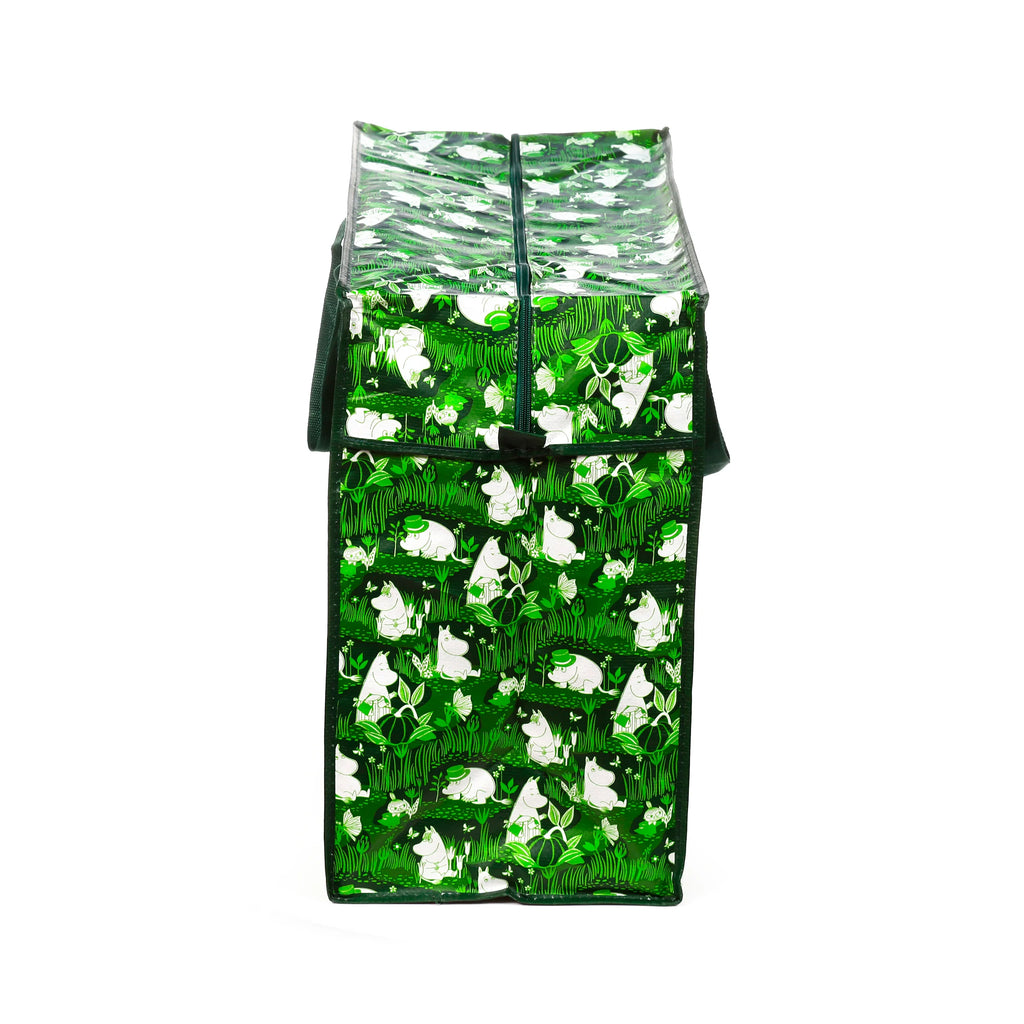 Upright green laundry and storage bag featuring a Moomin garden pattern with characters, plants, and butterflies, shown from an end-on view revealing the top zipper closure.