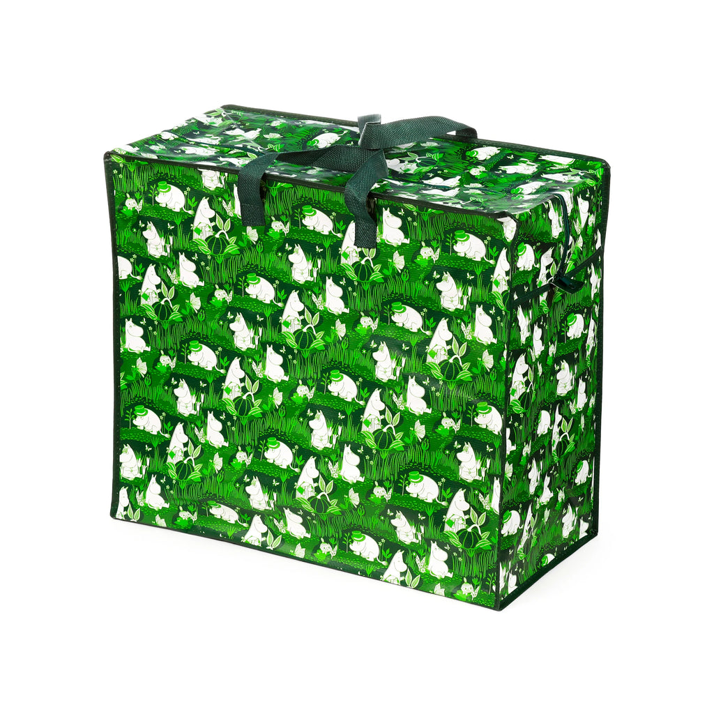 Angled view of a green laundry and storage bag, featuring a white Moomin Garden Life pattern with characters, foliage, and butterflies. The bag has dark green fabric handles and a visible zip closure.