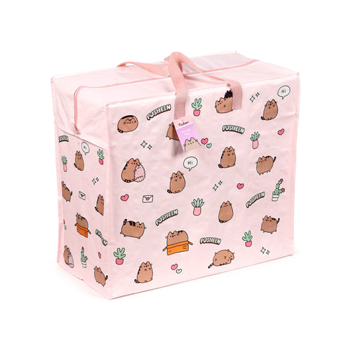 Angled view of a light pink laundry and storage bag, featuring a repeating pattern of cartoon Pusheen cats and various potted plants, with pink fabric handles and a top zip closure.