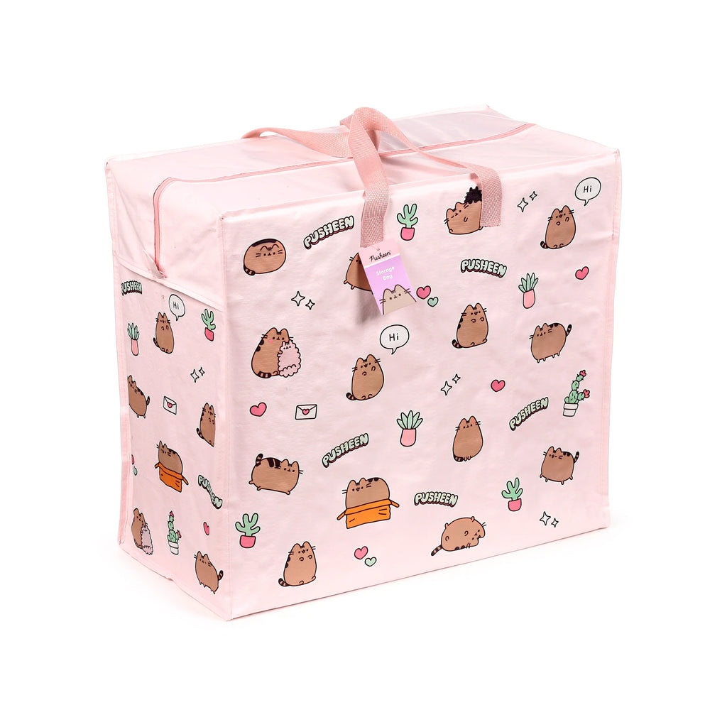 Angled view of a light pink laundry and storage bag, featuring a repeating pattern of cartoon Pusheen cats and various potted plants, with pink fabric handles and a top zip closure.