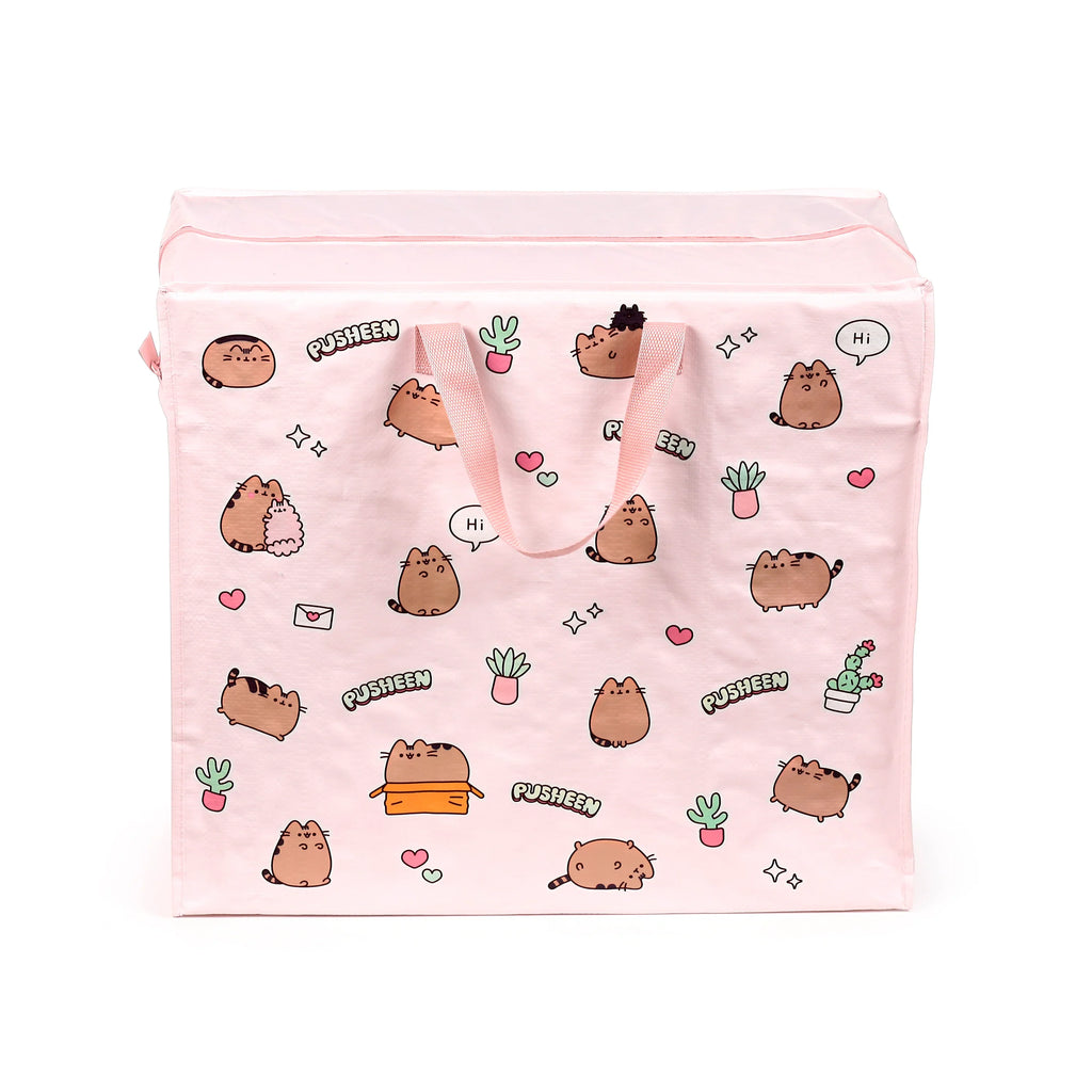 Front view of a pink laundry and storage bag with two fabric handles, featuring a colourful pattern of Pusheen the Cat, potted plants, hearts, and stars. The bag has a zippered top.
