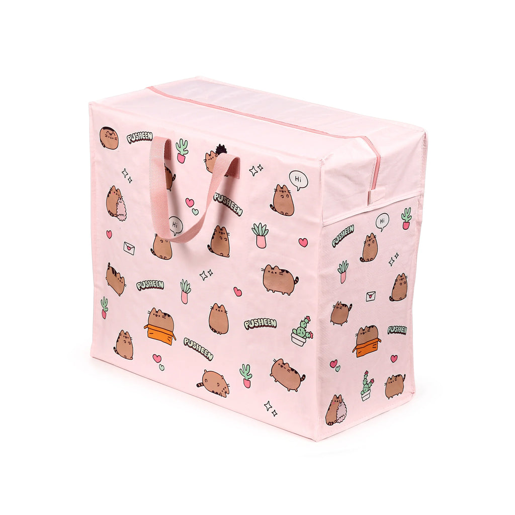 Angled view of a pink laundry and storage bag featuring a pattern of Pusheen the Cat illustrations, various potted plants, hearts, and stars. The bag has two fabric handles and a zip fastening along the top.