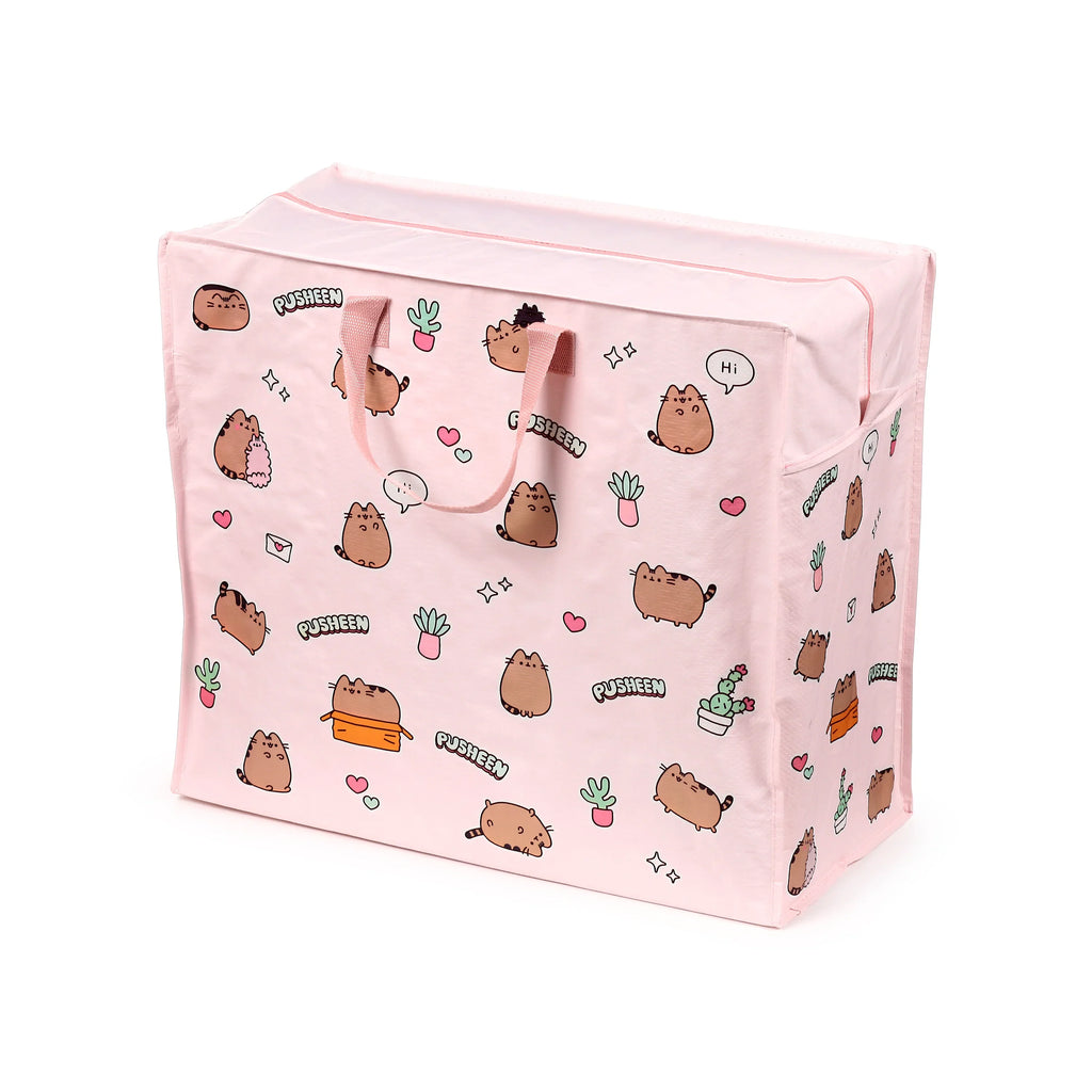 Angled view of a pink laundry and storage bag, featuring a pattern of Pusheen the Cat characters alongside various potted plants, hearts, and speech bubbles. The bag has two fabric handles and a zip closure along the top.