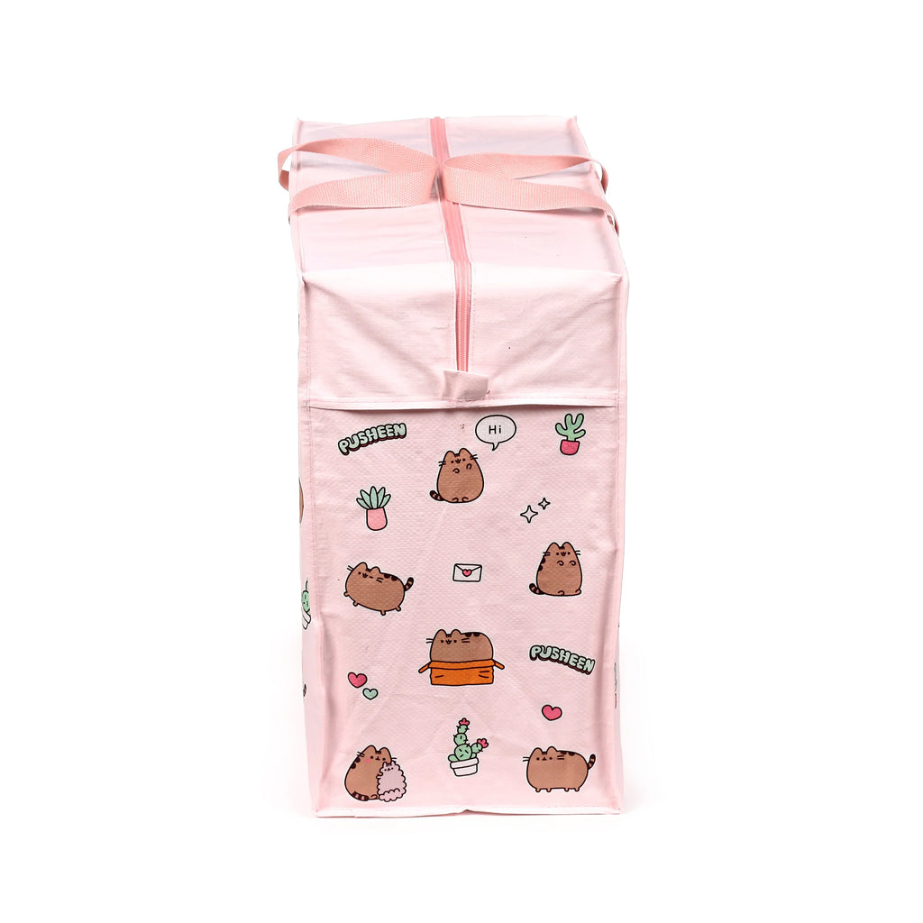 Front view of a pink laundry and storage bag, adorned with multiple illustrations of Pusheen the Cat, potted plants, hearts, stars, and Pusheen text. The bag features a zip closure and two pink webbing handles.
