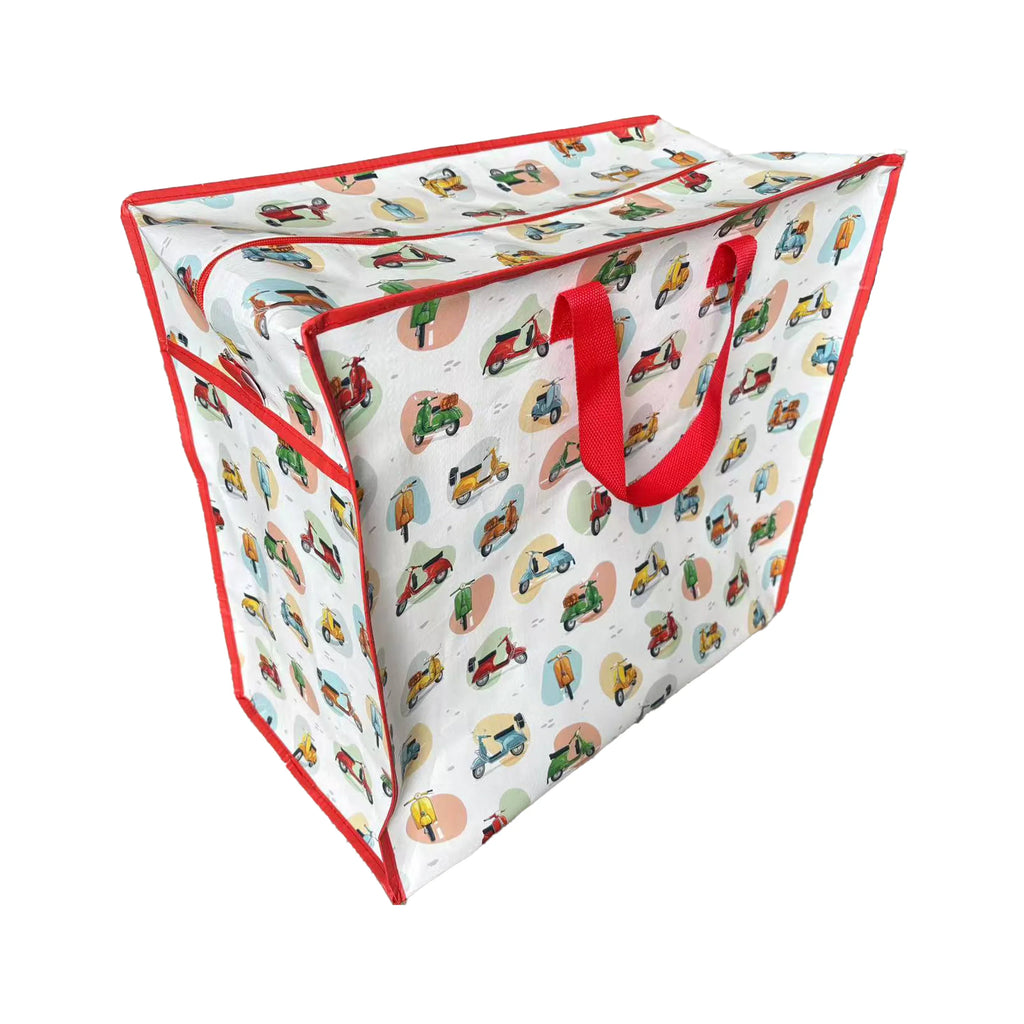 Angled view of a white laundry and storage bag with a colourful scooter pattern, red trim, and red fabric handles, featuring a zipped top.