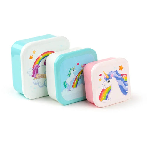 Angled view of three square lunch boxes, decreasing in size, each with a different colourful unicorn and rainbow design. The largest box has a white lid depicting a purple-maned unicorn, the medium box has a light blue lid showing a rearing unicorn on a rainbow, and the smallest box has a white lid with a unicorn head. All boxes have contrasting coloured bases and are decorated with stars and hearts.