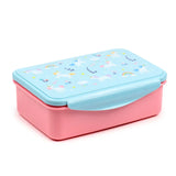 Angled view of a rectangular pink lunch box with a light blue lid featuring a unicorn magic design of white unicorns, rainbows, and clouds. A blue clip lock is visible on the front.