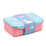 Angled view of a pink and light blue clip lock lunch box featuring a 'Unicorn Magic' design on the lid, with a descriptive paper band around it.