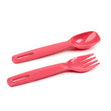 Angled view of coral pink plastic cutlery for a bento lunch box, showing a spoon and fork with slotted handles.