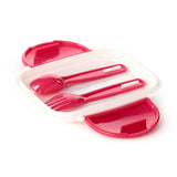 Angled view of an open white bento lunch box with fuchsia pink interior, revealing a matching spoon and fork.
