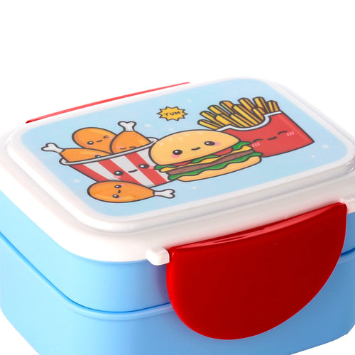 Angled view of a two-tiered light blue bento clip lock lunch box. The white lid features a colourful cartoon design of a smiling hamburger, a bucket of fried chicken, and a carton of chips. A red clip lock is visible on the side.