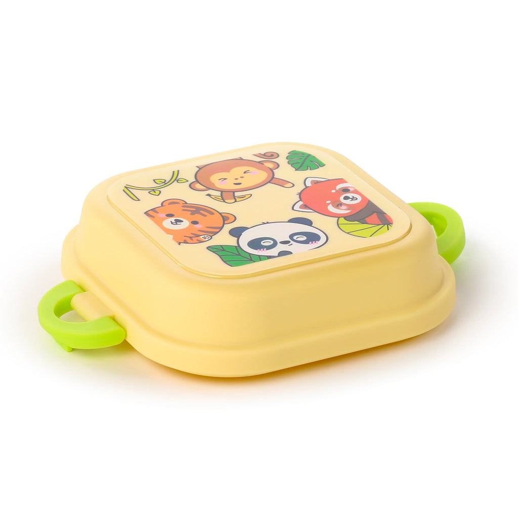 Angled view of a pale yellow bento clip lock snack lunch box with bright green clips, featuring a cartoon jungle animal design on its lid, depicting a monkey, tiger, panda, and red panda.