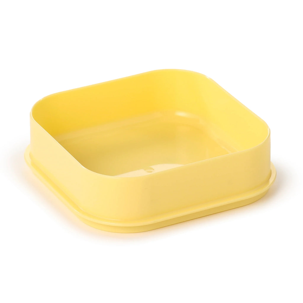 Yellow bento snack lunch box base, angled view.