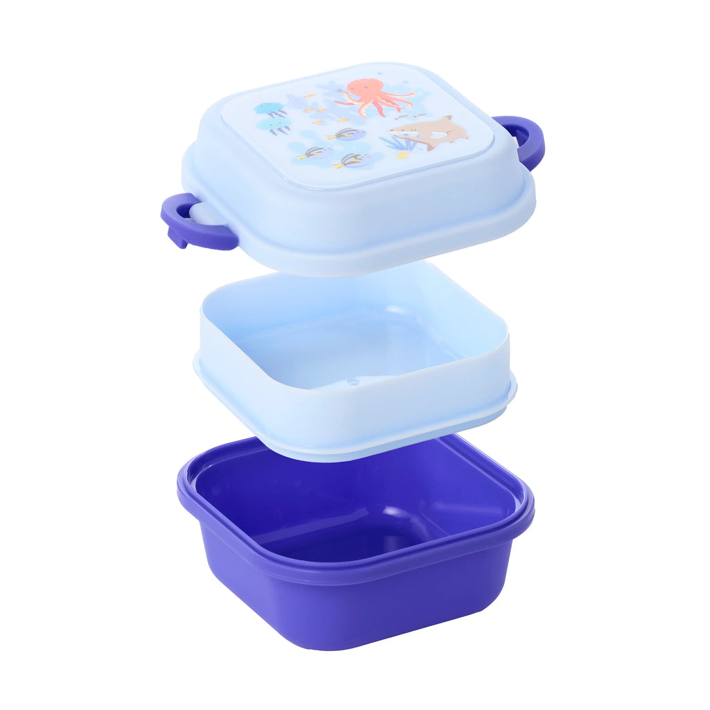 Exploded view of a square Bento Clip Lock Snack Lunch Box. The light blue lid features a Mariniverse design with an octopus, shark, and jellyfish, and has purple clip locks. The set includes a light blue middle tray and a dark purple bottom container.