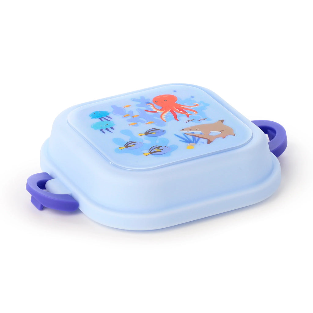 Elevated view of a light blue bento clip lock lunch box, featuring an illustration of an orange octopus, blue jellyfish, and assorted fish on its lid, with purple side clips.