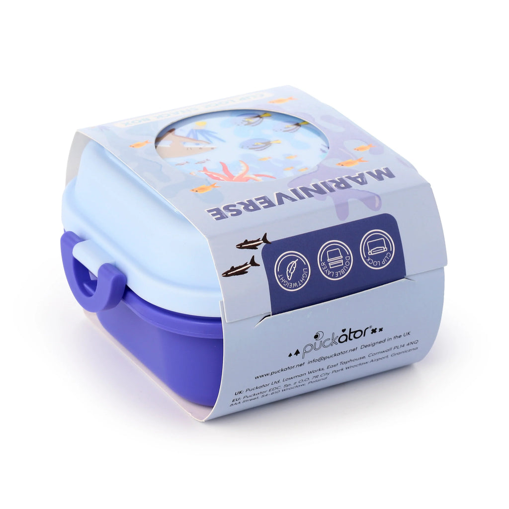 Angled view of a blue and purple Bento clip lock snack lunch box, displayed in its light blue retail packaging with a 'Mariniverse' marine life design.