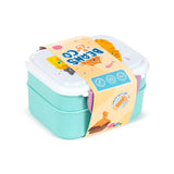Angled overhead view of a two-tiered aqua and white bento clip lock lunch box with purple clips, wrapped in an orange paper band decorated with 'Beans & Co' text, cartoon cat illustrations, and icons, including one for cutlery.