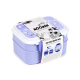 Angled view of a two-tier lavender clip lock bento box with a white lid featuring subtle heart patterns, and a white Moomin packaging band indicating dual compartments and including cutlery illustrations.