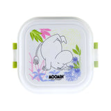 Overhead view of a white Moomin bento clip lock snack lunch box with a Moomin character illustration on the lid, surrounded by colourful flowers and featuring green clips.