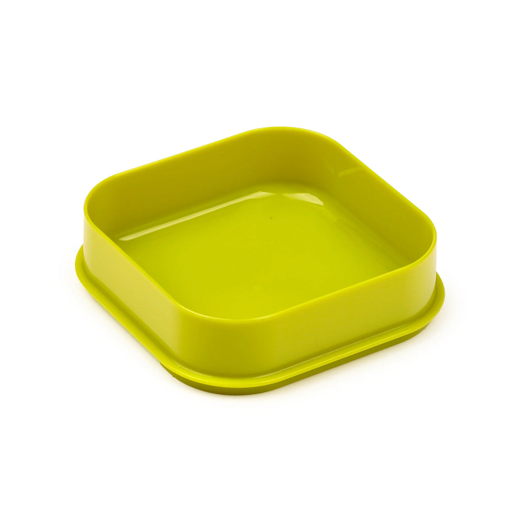 Lime green plastic square lunch box base with rounded corners, angled view.