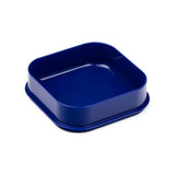 Angled view of a deep blue square bento snack lunch box base with rounded corners.