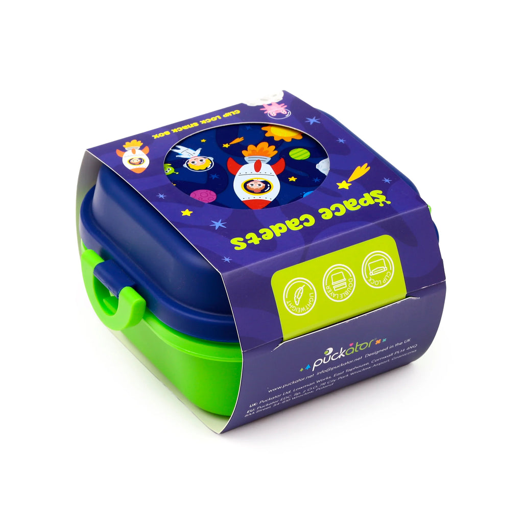Angled view of a blue and green bento clip lock snack lunch box, presented in a purple 'Space Cadets' themed sleeve depicting rockets, planets, and astronauts.