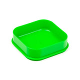 Angled view of an open, bright green plastic square lunch box base with rounded corners.