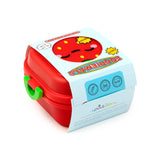 Angled view of a red Bento clip-lock snack lunch box with a green clip, showcasing the Elidi the strawberry character design on the lid. Light blue packaging partially wraps the box, displaying 'FOODIEMALS' and 'FRESH' text.