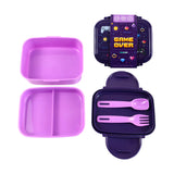 Two-tone purple bento lunch box components laid out, featuring a dark purple lid with 'Game Over' graphic and pixelated game icons, a separate light purple divided compartment, and a dark purple base containing matching light purple spoon and fork, with the clip-lock mechanism visible along its edges.