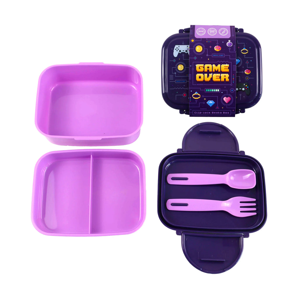 Two-tone purple bento lunch box components laid out, featuring a dark purple lid with 'Game Over' graphic and pixelated game icons, a separate light purple divided compartment, and a dark purple base containing matching light purple spoon and fork, with the clip-lock mechanism visible along its edges.
