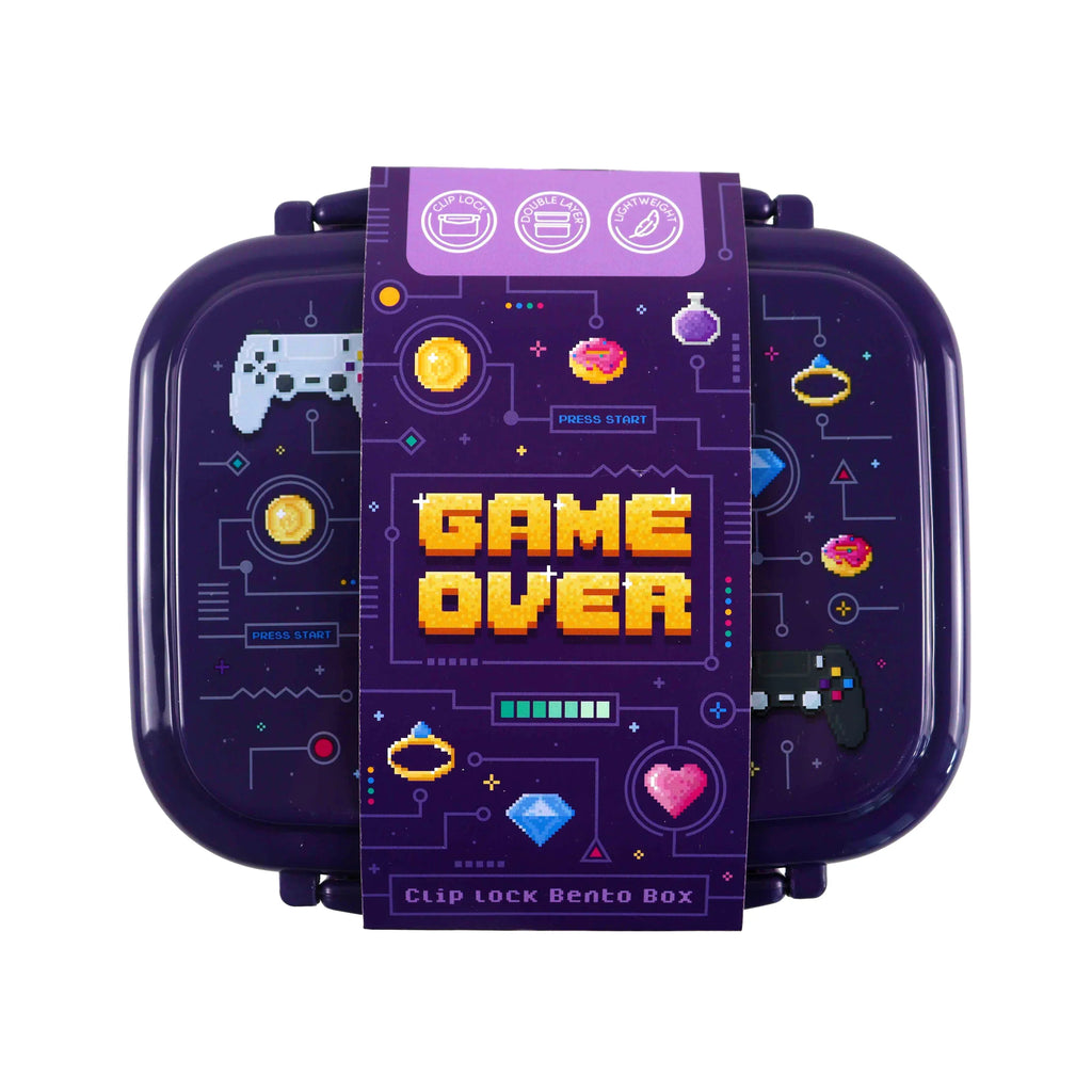 Overhead view of a dark purple clip lock bento box with a pixel art 'Game Over' design on its lid, featuring game controllers, coins, and hearts. A product sleeve, highlighting 'double layer' and 'lightweight' features, wraps around the lunch box.