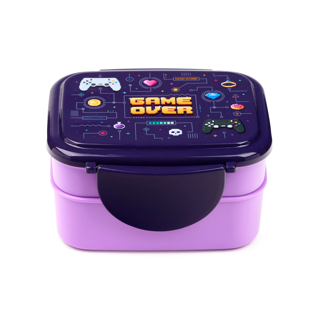 Purple and lilac two-tiered bento lunch box, showing the front with a clip lock and the lid's pixelated 'Game Over' design and gaming graphics.