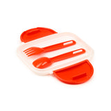 Angled view of an open white plastic bento lunch box with bright red clip locks, containing matching red plastic fork and spoon cutlery, set against a white background.