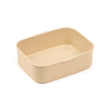 Angled view of an empty, cream-coloured, rectangular bento lunch box container.