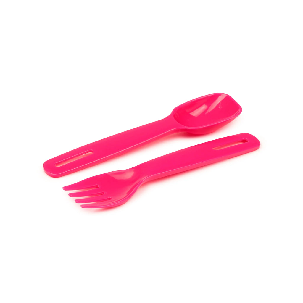 Close-up, angled view of a bright pink plastic fork and spoon, both featuring slotted handles.