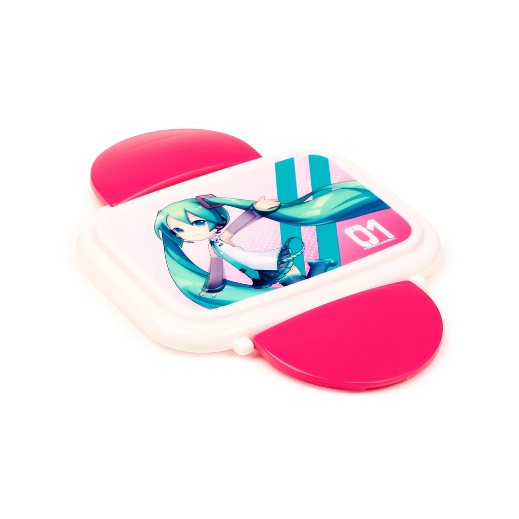 Angled view of a white bento clip lock lunch box, featuring a Hatsune Miku illustration on the lid with teal hair, a white and grey outfit, and pink accents, with bright pink clip locks.