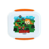Overhead view of a white bento clip lock lunch box with orange fastenings, featuring a colourful pixelated Minecraft design on the lid showing a green Creeper, Alex, TNT blocks, and the word 'BOOM!'.