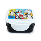 Angled front view of a black bento lunch box with a white lid, featuring a colourful comic strip design with Original Stormtroopers, action scenes, and speech bubbles. A large white semi-circular clip lock is visible on the front.