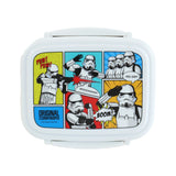 Overhead view of a white rectangular bento lunch box with rounded corners and visible side clip locks. The lid features a vibrant comic strip illustration of Stormtroopers in various action poses, with speech bubbles including 'PEW! PEW!', 'WOOOAAAHH!', 'BOOM!', and 'YES SIR!!'. The lid also displays 'ORIGINAL STORMTROOPER' text.